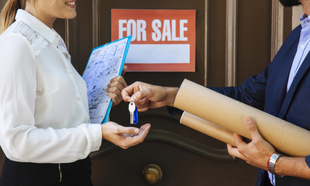 woman-receiving-key-from-real-estate-agent